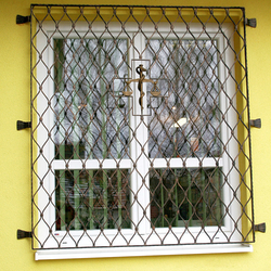 Hand-forged scales  a symbol of medicine  on the grilles of a pharmacy