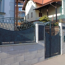 A wrought iron fence - metal and wrought iron combination